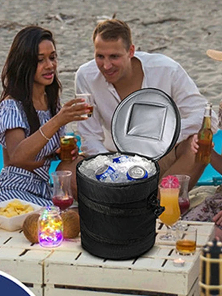 Picnic scene with a cooler bag open beside drinks and food
