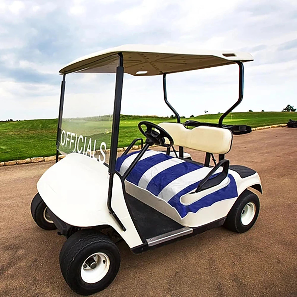 Blue and white striped seat towel shown on a white golf cart outdoors - Fairway Fort™
